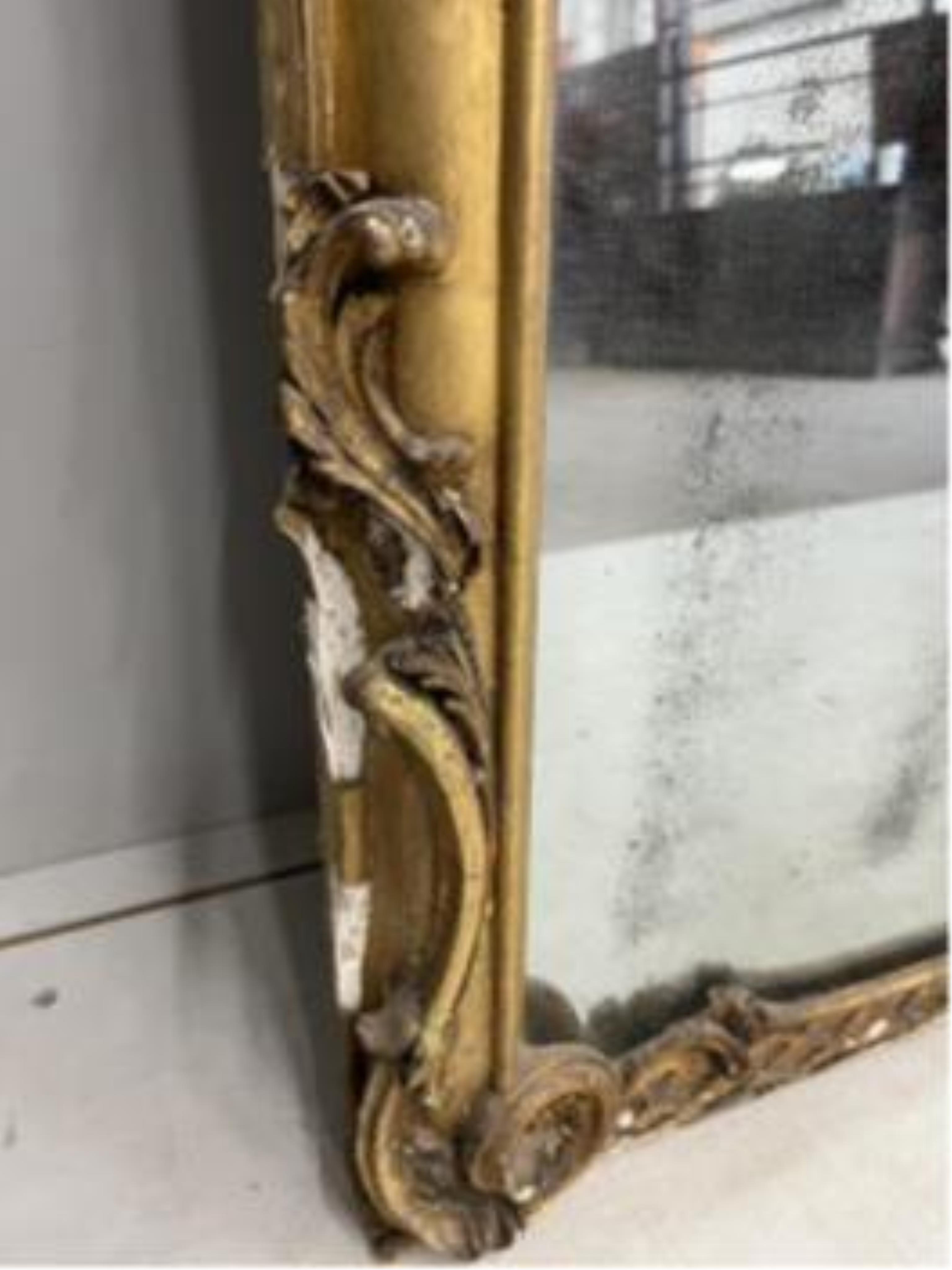 A Victorian carved giltwood and composition marble topped serpentine console table and mirror, width 132cm, height 177cm.